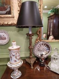 One of a pair each of French Limoges porcelains, brass Cathedral candlestick table lamps, English silverplated shell servers and small cloisonne vases, on wooden stands.