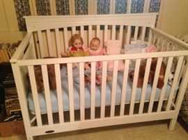Baby dolls and a baby bed