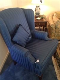 One of two blue wingback chairs