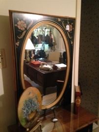 Oval mirror above the cabinet