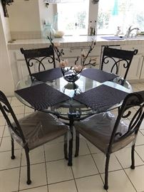 Glass table with four chairs