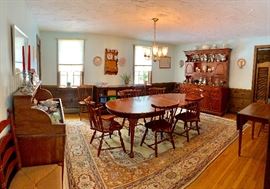 Cherry oval dining table with 2 leaves & pads along with 6 brace-back Windsor chairs by Pennsylvania House