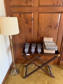 Bombay mahogany butler's tray on stand together with 3 sets of 6 crystal glasses and a brass floor lamp