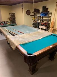 Pool table "custom original" by Delta along with a cue and ball rack
