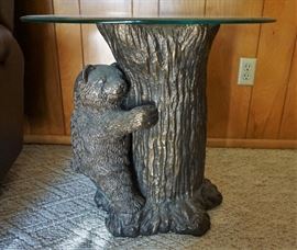 Cute bear cub in a tree table