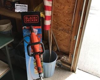 Electric Black & Decker Weedwhacker and American flag and pole