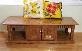 This piece can be used as a table or at the end of a bed. More storage.