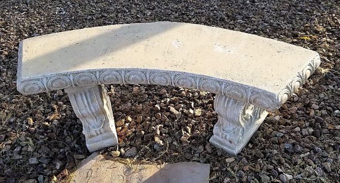 Cement curved garden bench.