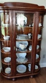 Unusual display case with curved glass sides and wooden shelves. Excellent condition.