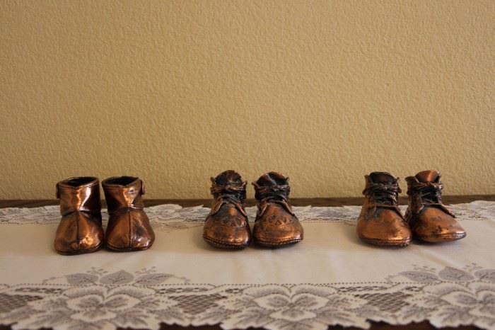 3 pairs of bronzed baby shoes