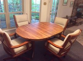  Very nice butcher block top kitchen table with one leaf and four very comfortable rolling chairs 