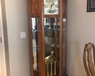 Howard Miller grandfather clock with glass shelving on each side - 82”H