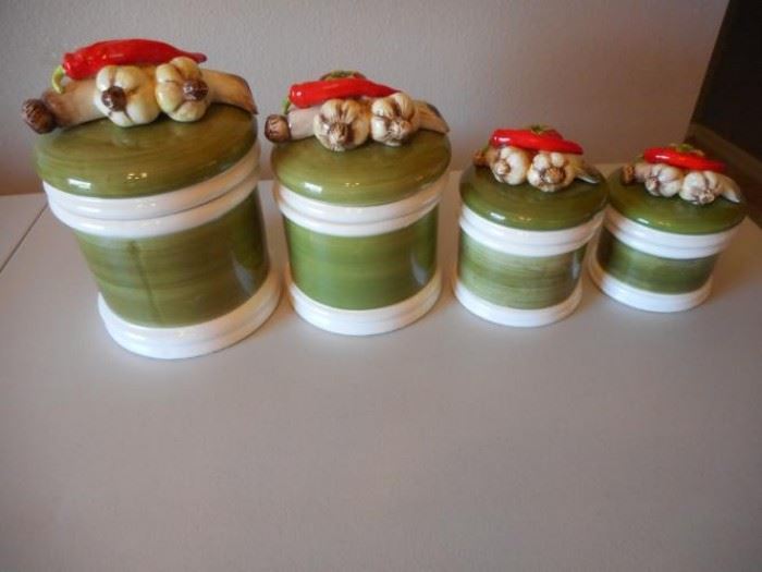 Green and white ceramic canister set with vegetable handles https://ctbids.com/#!/description/share/139220