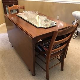  Antique cherry table with 4 leaves and 4 matching chairs.