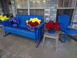 Vintage metal Glider and metal Chair. Outside Flower arrangements.