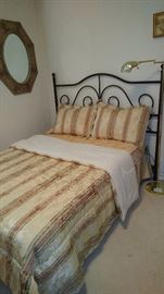 Full bed with iron queen headboard.