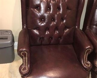 TWO BROWN LEATHER STUDDED ARMCHAIRS