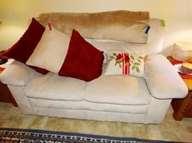 small sofa, pillows, blankets, throws