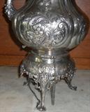 chasing work and base detail on highly chased, English tilting coffeepot (silver on copper), ca. 1870-80