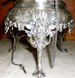 detail on base of highly chased, English tilting coffeepot (silver on copper), ca. 1870-80