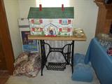 vintage dollhouse; table made from base of Singer treadle model sewing machine; linens (master bedroom)