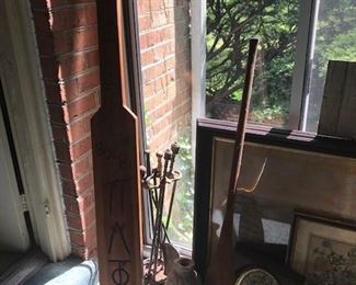 Wooden Oars and vintage fireplace equipment.