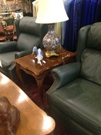 Two of four green leather recliners; one of two matching lamps and side tables 