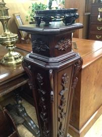 Ornately carved statue or plant stand