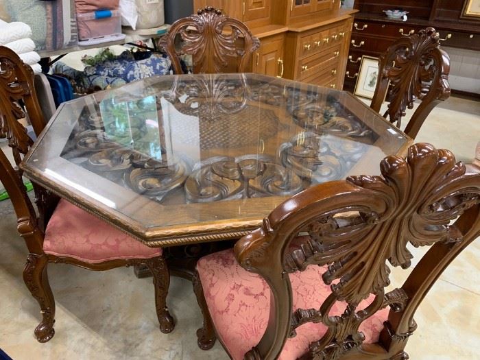 Four matching chairs; octagon shaped glass top table