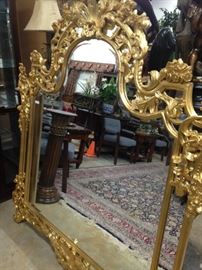 Another ornately  gold framed mirror 