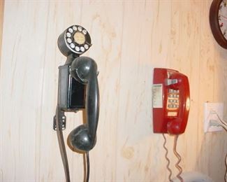 The black dial phone as originally designed and engineered by this man's father working for the Bell System who got the paten for same of course. Still working as is the red one.