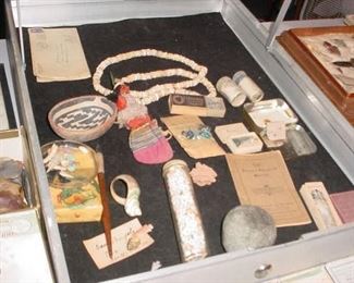 Indian painted stone bowl, hand crafted Indian doll, woven bag, boxes and glass tubes of hand cut Beads, small box left of middle has two Egyptian Scarabsd, dated 2000 BC, and the envelope to the left has Egyptian glass bead Amulets, same era.