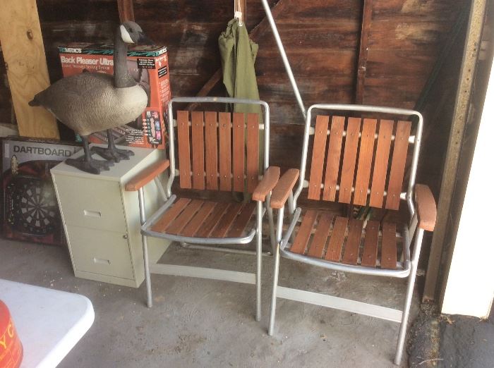 Wood vintage lawn chairs and a large goose