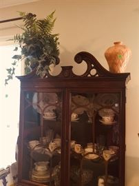 The mahogany China cabinet with the beautiful China and crystal.