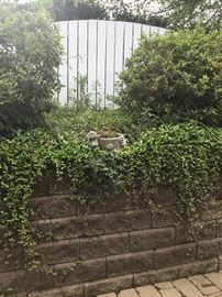 The cement flower pot with rabbits.