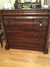 The beautiful antique mahogany chest with twisted sides.