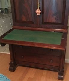 Desk let down on mahogany secretary.
