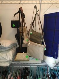 Some of the purses in closet with other items.
