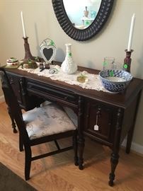 The mahogany ladies desk with drawers, newly upholstered cushion on desk chair.