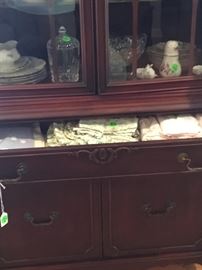 Napkins, place mats in China cabinet.
