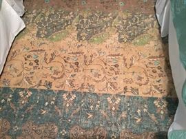 The area rug in bedroom. Looks like water colors.