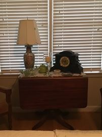 Mahogany drop leaf table with beautiful antique black clock.