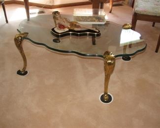 Brass legged sculpted glass-top table