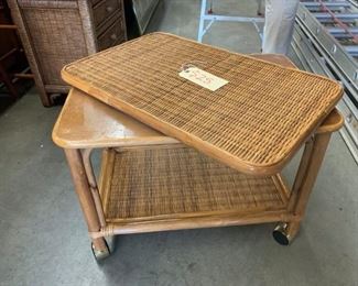 Wicker TV table. Swivel with bottom shelf.    On rollers.  25"w  x 16"d  x 20"t     Very Good Condition   $25.