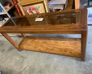Sofa table made of pecan solids with glass top. Wicker weave visible through glass top. 52"w x 15"d x 27"t         
Great condition  $50