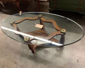 Thomasville oval cocktail table.  Pecan base with gold accents and beveled glass top.                                              55"w x 27"d x 17"t     Very good condition      $75.