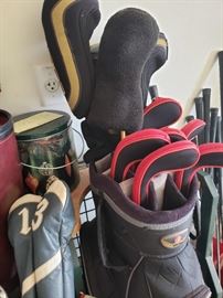 Lots of golf stuff- bags and clubs