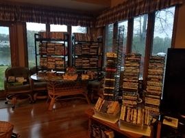 Plethora of CDs and DVDs
Glass Top Wicker Base Table w 6 Upholstered Comfy Chairs on Wheels