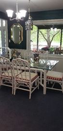rattan glass top table, chairs, red/white cushions, brass framed mirror