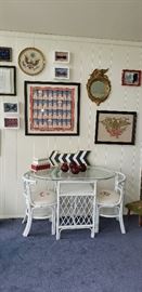 white wicker/glass top table, 2 chairs monogrammed, but can be easily changed. Framed prints, needlework, bow ties in background